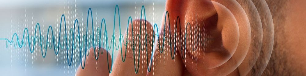 An ear is visible with a hand cupping the ear lobe. Sound waves are shown coming out of the ear.